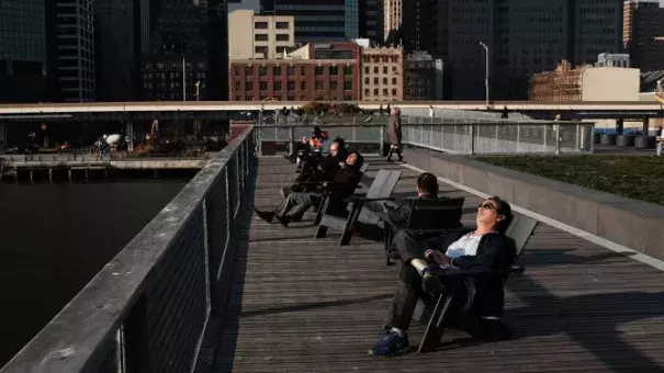 People enjoy unseasonably warm weather in lower Manhattan in December. Photo: Getty