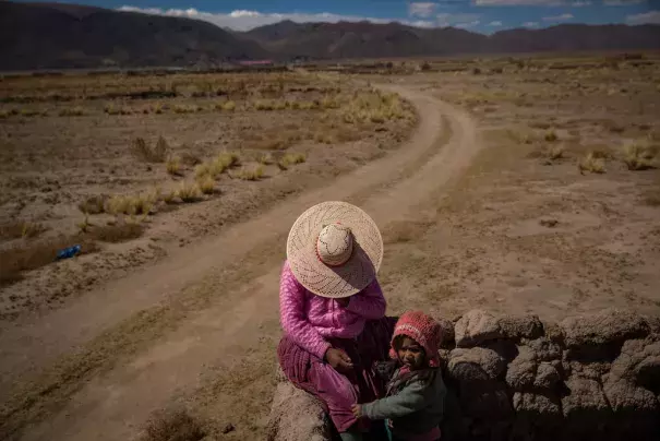 Agustina Rios Moya, 22, with her daughter in the ruins of a family house. Photo: New York Times