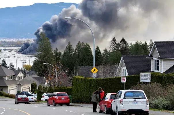 A fire last week in Abbotsford, in British Columbia near the United States border. Days earlier rainstorms lashed the province,  prompting landslides and floods and closing highways. (Credit: Jennifer Gauthier/Reuters)