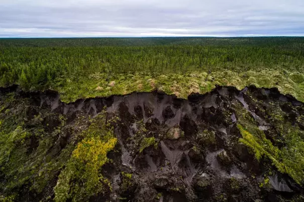 Ground collapses at Duvanny Yar, a permafrost megaslump along the Kolyma River in northern Siberia. New research suggests that some land in Arctic Alaska and Russia may no longer freeze at all. This constantly moving landslide, driven by erosion and sped up by warming temperatures, is an important research site for scientists, who use it to track what happens as carbon-rich land that has been frozen for centuries begins to thaw. Photo: Katie Orlinsky, National Geographic