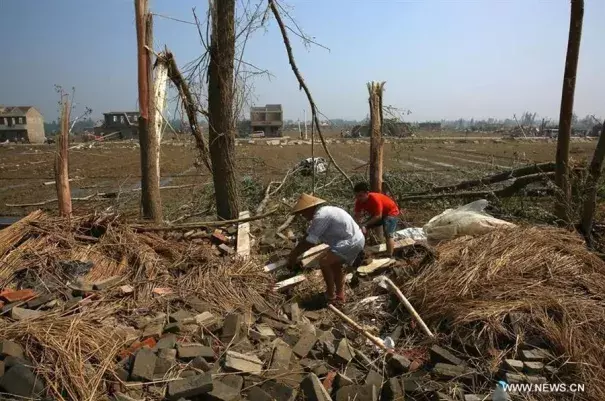 Villagers clear off debris in Danping Village of Chenliang Township in Funing County of Yancheng City, east China's Jiangsu Province, June 25, 2016. Rain, hail and a tornado battered parts of Yancheng City on Thursday afternoon, destroying buildings, trees, vehicles and electricity poles. Photo: Xinhua