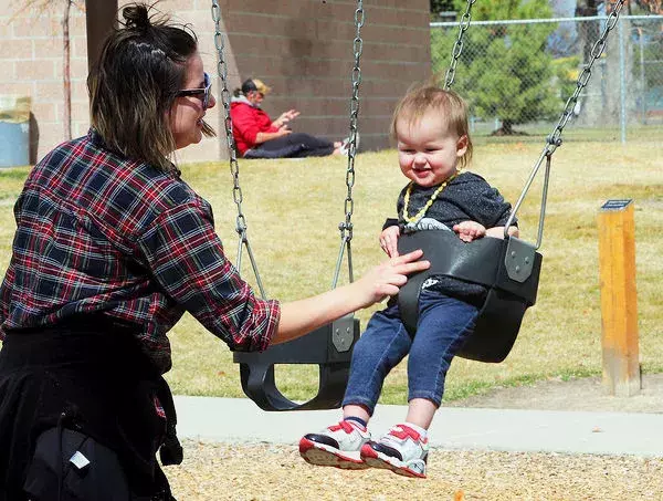 Victoria Westfall of Grand Junction, pushes her son, Isildur Westfall, on the swings at Lincoln Park on a warm afternoon. Photo: Daily Sentinel