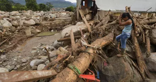 A survivor on Sunday amid the damage caused by a mudslide after heavy rains in Mocoa, Colombia. Photo: Credit Luis Robayo, Agence France-Presse