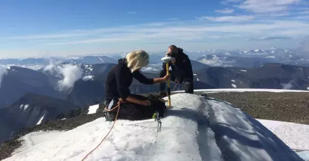 Gunhild Rosqvist, a Stockholm University geography professor, making measurements atop the southern tip of Kebnekaise, formerly Sweden’s highest peak. Photo: Carl Lundberg, Stockholm University, via Agence France-Presse/Getty Images