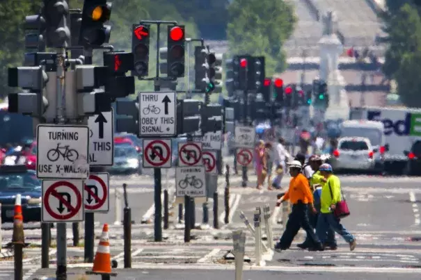 Construction workers cross Pennsylvania Avenue as the temperature reaches 98 degrees Fahrenheit in Washington on Monday. Photo: Jim Lo Scalzo / European Pressphoto Agency