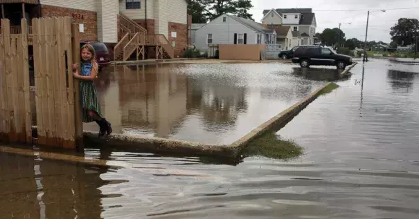 Chloe Riffle, 7, on a flooded street in Norfolk, Va., on Sunday. Photo: Vicki Cronis-Nohe/The Virginian-Pilot, via Associated Press