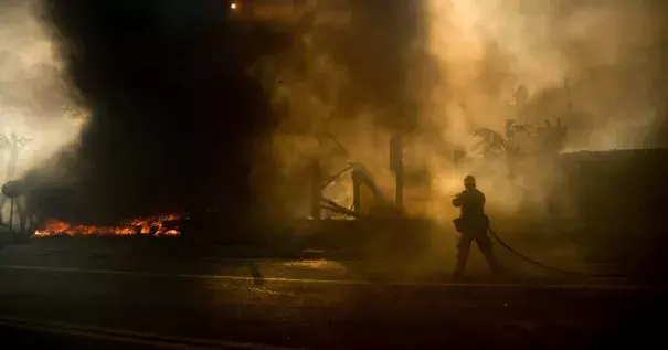 A firefighter trying to contain a wildfire in Ventura, Calif. More than 1,000 firefighters are battling the flames. Photo: Noah Berger, Associated Press