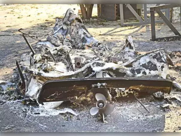 The propeller remains attached to the hull of a fiberglass motor boat that melted in the flames of the Sand Fire. Photo: Dan Watson