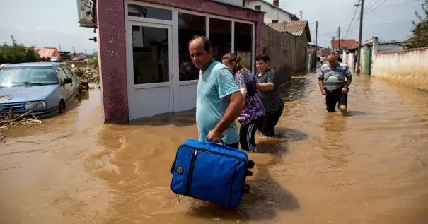 People fled their flooded homes Sunday in the village of Stajkovci, near Skopje, Macedonia. Photo: Robert Atanasovski/Agence France-Presse