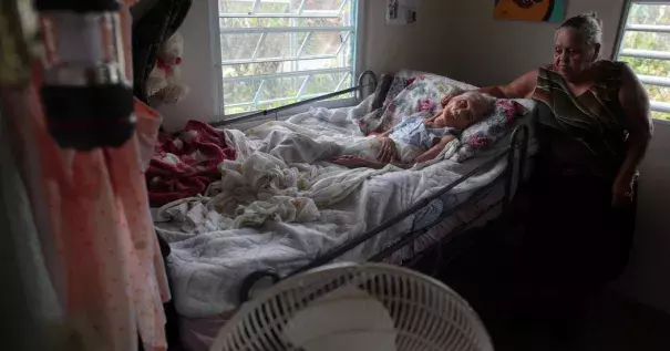 After Hurricane Maria destroyed the town’s bridge in San Lorenzo, Morovis, P.R., family members were trying to get Rosa Maria Torres, 95, airlifted out of the town. “If they don't move her out of here, she’s going to die,” said Carmen Santos, Ms. Torres’s granddaughter. Photo: Alvin Baez, Reuters