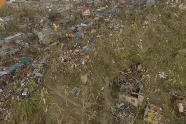 In this photo provided by the Philippine Navy, damaged houses and toppled trees lie in Dinagat Island, Surigao del Norte province, southern Philippines on Friday, Dec. 17, 2021. The governor of an island province in the central Philippines said dozens of people died in the devastation wrought by Typhoon Rai in just half of the towns that managed to contact him, bringing the death toll in the strongest typhoon to batter the country this year to nearly 100. (Philippine Navy via AP)