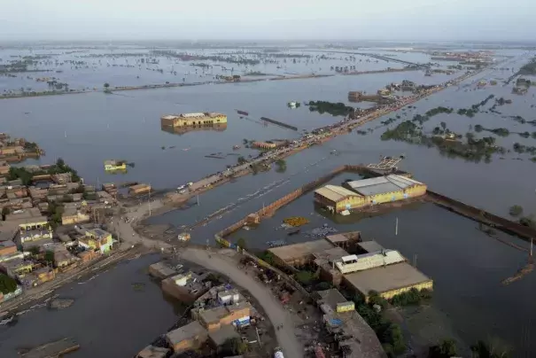 FILE - Homes are surrounded by floodwaters in Sohbat Pur city, a district of Pakistan's southwestern Baluchistan province, Aug. 29, 2022. A new study says human-caused climate change juiced the rainfall that triggered Pakistan's floods by up to 50%. But the authors of the Thursday, Sept. 15, study say other societal issues that make the country vulnerable and put people in harm's way are probably the biggest factor in the ongoing humanitarian disaster. (AP Photo/Zahid Hussain, File)