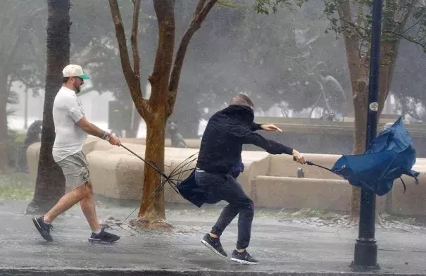 Wind gusts, blowing down King Street, twist umbrellas during Hurricane Ian in Charleston, S.C., on Friday, Sept. 30, 2022. (Grace Beahm Alford/The Post and Courier via AP)