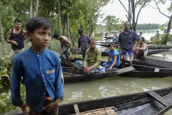 Flood affected people wait to receive relief material in Sylhet, Bangladesh, Wednesday, June 22, 2022. (Credit: AP Photo/Mahmud Hossain Opu)