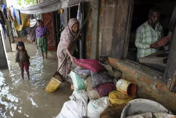 People inspect the damaged belongings in their homes as flood water levels recede slowly in Sylhet, Bangladesh, Wednesday, June 22, 2022. (Credit: AP Photo/Mahmud Hossain Opu)