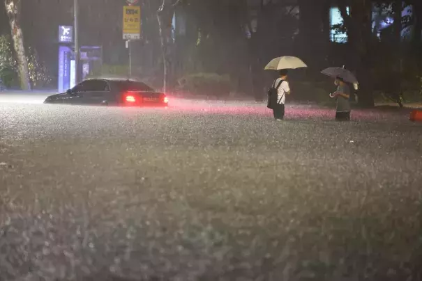 A vehicle is submerged in a flooded road in Seoul, Monday, Aug. 8, 2022. Heavy rains drenched South Korea's capital region, turning the streets of Seoul's affluent Gangnam district into a river, leaving submerged vehicles and overwhelming public transport systems. (Credit: Hwang Kwang-mo/Yonhap via AP)