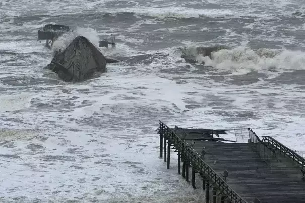 A section of the Seacliff State Beach Pier is decimated from heavy storm surf, Thursday, Jan. 5, 2023, in Aptos, Calif. Damaging hurricane-force winds, surging surf and heavy rains from a powerful "atmospheric river" pounded California on Thursday, knocking out power to tens of thousands, causing flooding, and contributing to the deaths of at least two people. (Credit: Shmuel Thaler/The Santa Cruz Sentinel via AP)