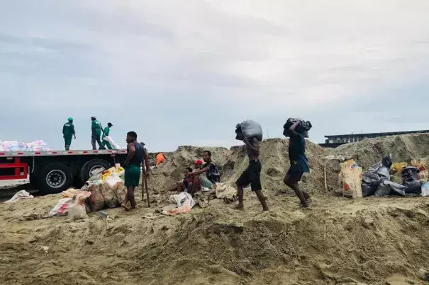 People make their way home during bad weather in Tamatave, Madagascar, Saturday, Feb. 5, 2022 in advance of the landfall of Cyclone Batsirai which hit Madagascar Saturday evening. (AP Photo)