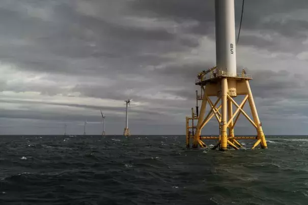 The five turbines of America's first offshore wind farm, owned by the Danish company, Orsted, stand off the coast of Block Island, R.I., Monday, Oct. 17, 2022. Hundreds of offshore wind developers and experts gathered in Rhode Island to talk about the future of clean energy— how to grow the offshore wind industry and address shared challenges. (Credit: AP Photo/David Goldman)