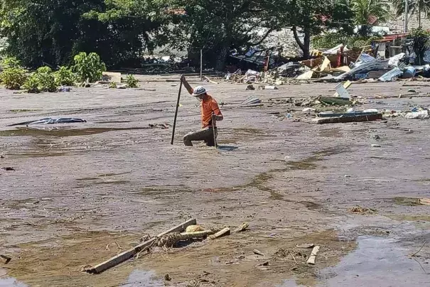 In this photo provided by the Philippine Coast Guard, a rescuer continues search for missing bodies at Barangay Kusiong, Datu Odin Sinsuat, Maguindanao province, southern Philippines on Monday Oct. 31, 2022. Several people have died in one of the most destructive storms to lash the Philippines this year with dozens more feared missing after villagers were buried in a boulder-laden mudslide. (Credit: Philippine Coast Guard via AP)