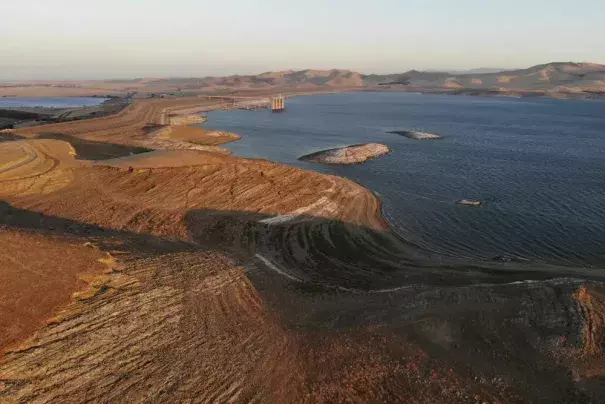 FILE - Water levels are low at San Luis Reservoir, which stores irrigation water for San Joaquin Valley farms, Sept. 14, 2022, in Gustine, Calif. California Gov. Gavin Newsom announced an end to some drought restrictions and calls for water conservation on Friday, March 24, 2023, following a series of winter storms have dramatically improved the state's water supply outlook. (Credit: AP Photo/Terry Chea, File)