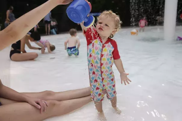 Ava Owens gets a cool shower from her mom Laura Owens at a pool in Hasting-on-Hudson, N.Y. Photo: Seth Wenig, AP