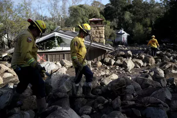 Firefighters search for people trapped in mudslide debris in Montecito, California in 2018.