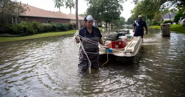 Lisa Montemayor, an environmental investigator with the Houston Health Department, and Jesse Crain III, an environmental assessor with the Environmental Health Service at the Baylor College of Medicine, collecting water samples last week in Houston neighborhoods affected by flooding from Hurricane Harvey. Photo: Eric Thayer, The New York Times