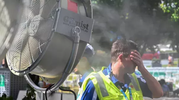 A man cools down in front of a mist fan for relief from the hot weather in Melbourne on Jan. 25, 2019. Photo: Saeed Khan, AFP/Getty Images