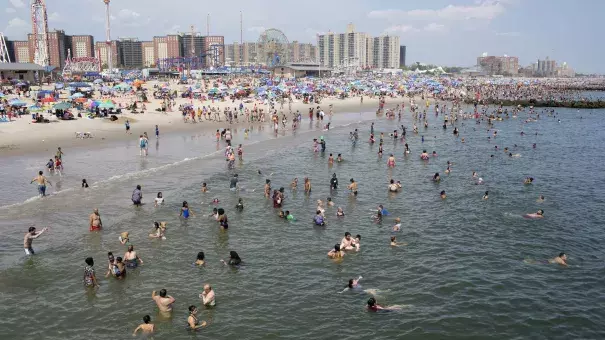 People seek refuge from the searing heat at the beach in Coney Island, New York City. Credit: Andrew Lichtenstein, Corbis via Getty Images
