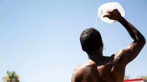 A person cools off in July in Phoenix, Arizona, which experienced its hottest and driest summer on record this year. (Credit: Brandon Bell/Getty Images)