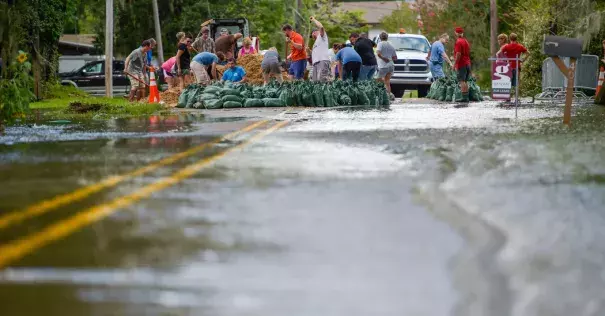 Volunteers pitched in to help residents fill sand bags against flooding from the Vermilion River in Lafayette, La., on Monday. Photo: Scott Clause/The Daily Advertiser, via Associated Press