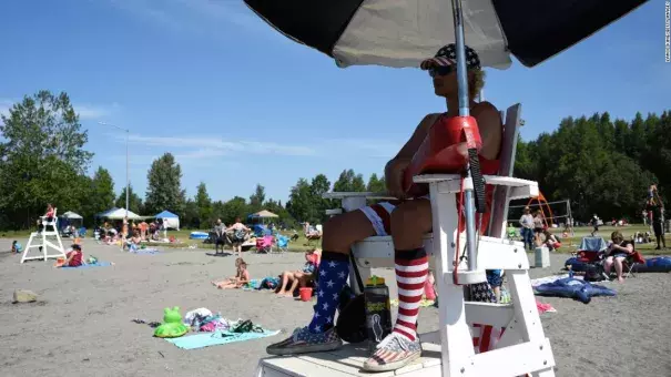 Lifeguard Luke Orot watches over swimmers at Jewel Lake on a hot July 4 in Anchorage. Photo: Lance King, Getty Images