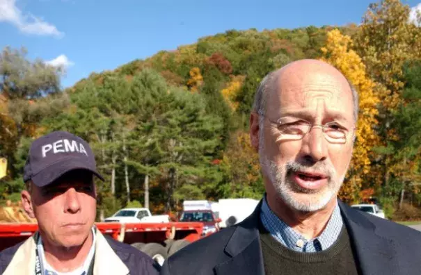 Gov. Tom Wolf speaks to the media in Warrensville Sunday after being briefed about the Sunoco pipeline break and flash flood damage in Lycoming County. At left is Richard D. Flinn, director of the Pennsylvania Emergency Management Agency. Photo: John Beauge