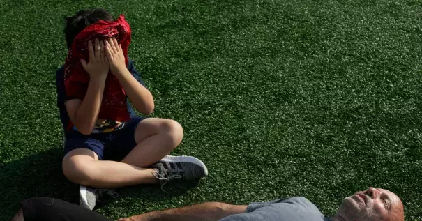 Milo Maimone, 8, and his dad, Tony, rest after working out at the McCarren Park track in Brooklyn on Sunday. Credit: Gabriella Angotti-Jones for The New York Times