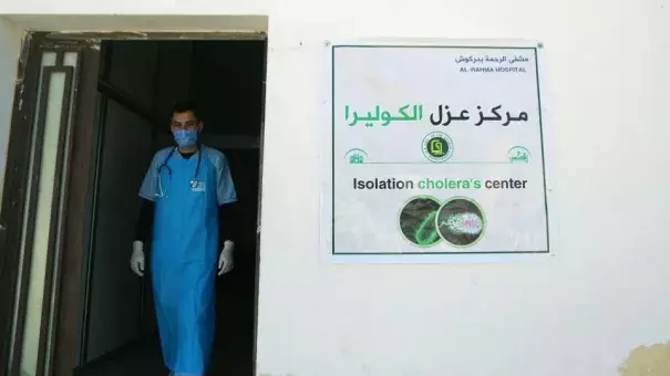 A medic walks at a recently opened medical center for cholera cases in the Syrian town of Darkush, on the outskirts of the rebel-held province of Idlib, on Saturday. (Credit: Aaref Watad/AFP/Getty Images)