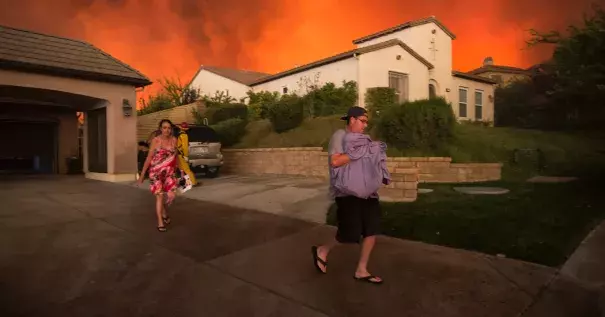 People left their homes on Saturday as a wildfire approached Santa Clarita, Calif. Photo: David Mcnew / Agence France-Presse / Getty Images