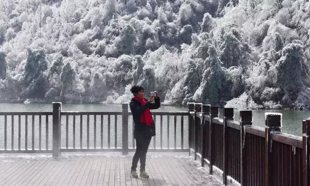 A woman photographs the scene at Hangzhou, in eastern China’s Zhejiang province. In Inner Mongolia, the temperature fell to a record low of -46.8C (-52F). Photo: AFP, Getty