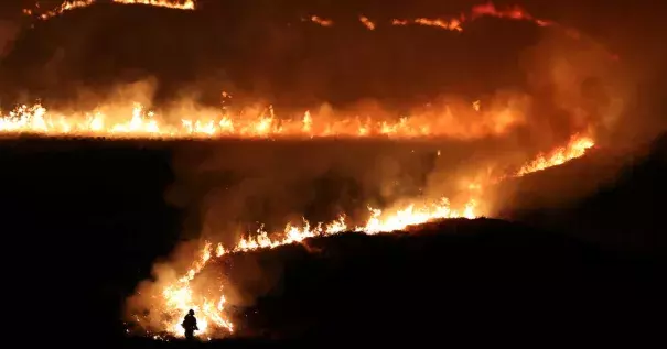 Firefighters tackled a blaze on Marsden Moor in northwest England that began on Tuesday night. Photo: Jon Super, Reuters