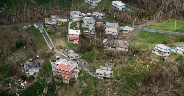 Houses that suffered damage from Hurricane Maria in San Juan, P.R., last October. Photo: Doug Mills, The New York Times