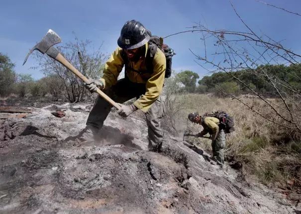 Mike Trubman, left, works with fellow Black Mesa Type-1 Interagency Hotshot Crew member Steve Daly, right, to mop up hot spots along Cienega Creek east of Empire Ranch while the Sawmill Fire burns on April 27, 2017, burning in Southeastern Arizona between Green Valley and J-6. Photo: Mike Christy, Arizona Daily Star