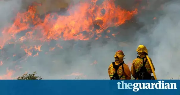 Helicopters sucked water out of a reservoir to drop on flames while air tankers bombarded the flanks of the fire with retardant. Photo: Mike Blake / Reuters
