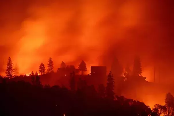 In this photo taken on November 10, 2018 Flames from the Camp fire burn near a home atop a ridge near Big Bend, California. Photo: Josh Edelson, AFP/Getty Images