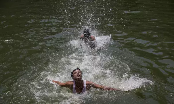 Boys swimming to cool off as record temperatures of 51C were recorded in the Indian city of Phalodi. Photo: AP
