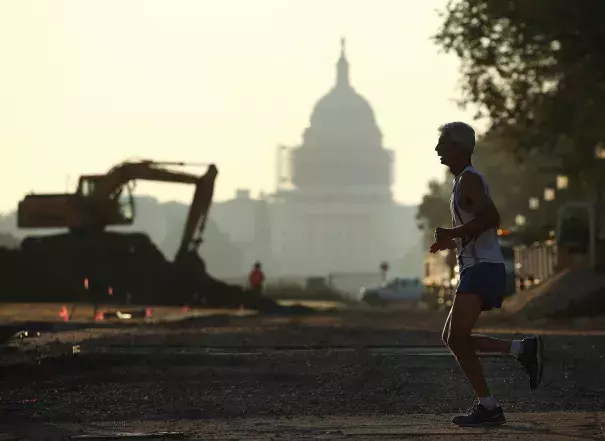 The Capitol can be seen as a jogger runs along the National Mall on July 21 in Washington, where area temperatures are forecasted to reach the upper 90s for the next few days. Photo: Mark Wilson / Getty Images