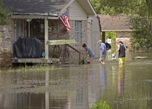 Homeowners return to their flooded home on Prince Road in St. Amant during Ascension Parish flooding and cleanup on Thursday, August 18, 2016. Photo: Bill Feig