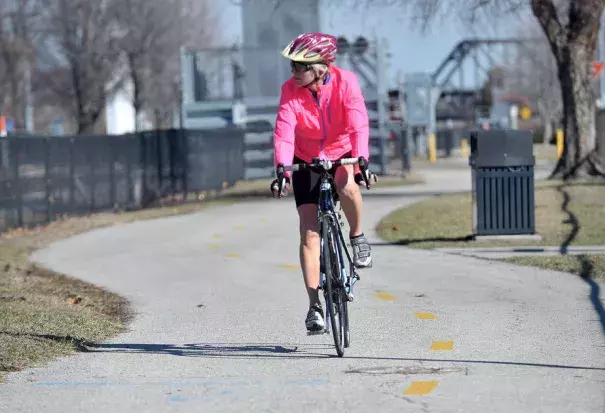 Linda Lewis of Davenport rides her bike along the path in downtown Davenport as temperatures reached in to the upper 60s on Tuesday, February 21, 2017. Photo: Gary Krambeck