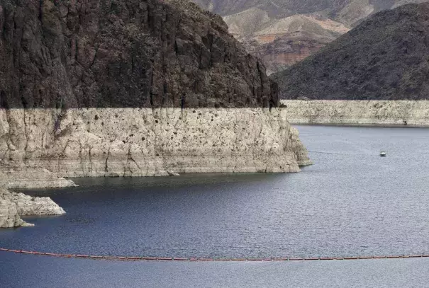In this April 16, 2013 file photo, a "bathtub ring" marks the high water mark as a recreational boat approaches Hoover Dam along Black Canyon on Lake Mead. Photo: Julie Jacobson, AP, File