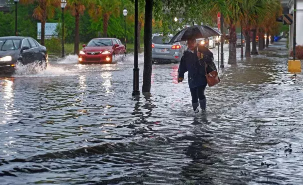 Traffic moves through a flooded King Street in Charleston on Monday, April 24, 2017. Photo: Matthew Fortner