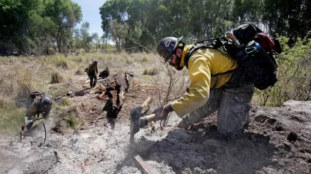 Mike Trubman, right, works with fellow Black Mesa Type-1 Interagency Hotshot Crew members Steve Daly, left, and Sean Hosier to mop up hot spots along Cienega Creek east of Empire Ranch while the Sawmill Fire burns on April 27, 2017, burning in Southeastern Arizona between Green Valley and J-6. Photo: Mike Christy, Arizona Daily Star